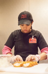 Yati, a chef at Sushi With Gusto, carefully prepares a roll on Jan. 29.  Photo by Daniel De Zamacona