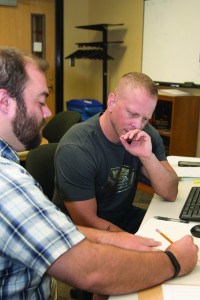 Taking advantage of the tutoring the Veteran's and Military Student Resource Center, student and veteran Donny Whitton (right) and Math Resource Center tutor Thomas Parra (left) tackle Whitton's MyMathLab assignment.