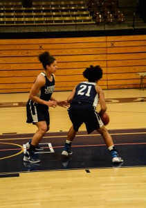 Kierra Isaiah, right, and Kayonna Lee of the women’s basketball team practice their defensive and offensive skills. Photo by Andrew Hartnett 