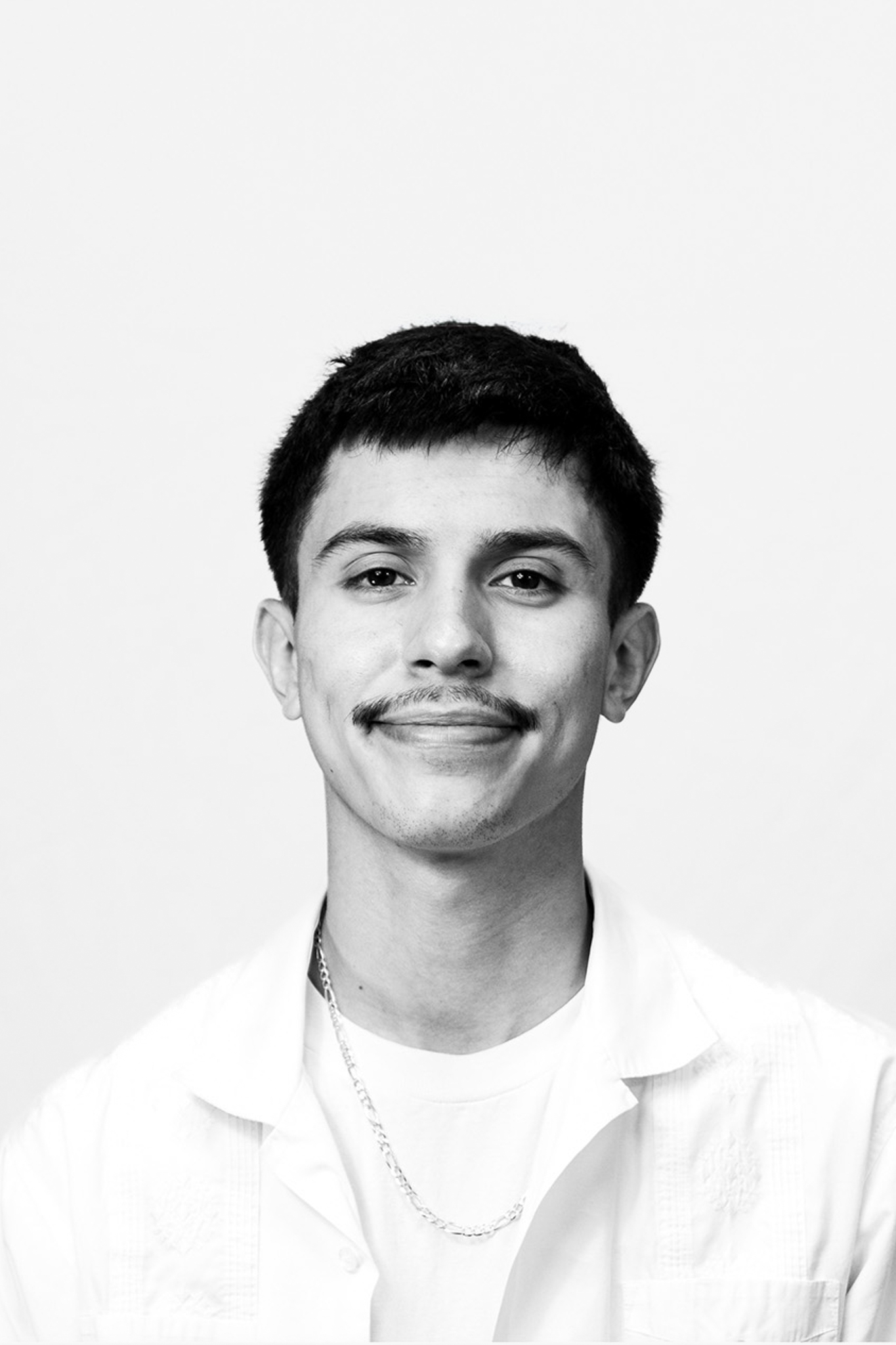 Brunette man with short hair and mustache