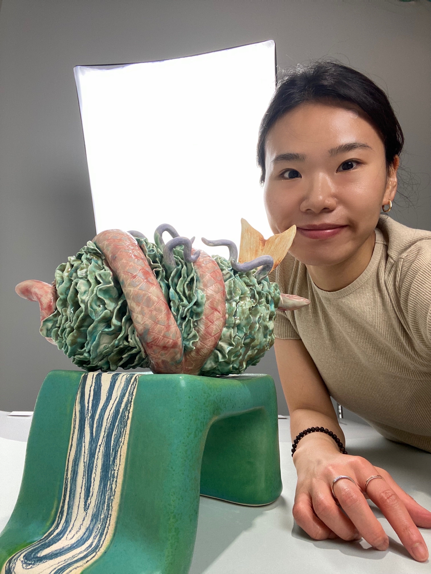Woman next to botanical sculpture