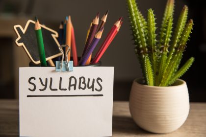 Syllabus inscription and pencils on the table